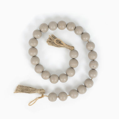 Click here to see Adams&Co 15632 15632 24x1x1 wood bead garland with tassels, grey Cozy Cottage Collection